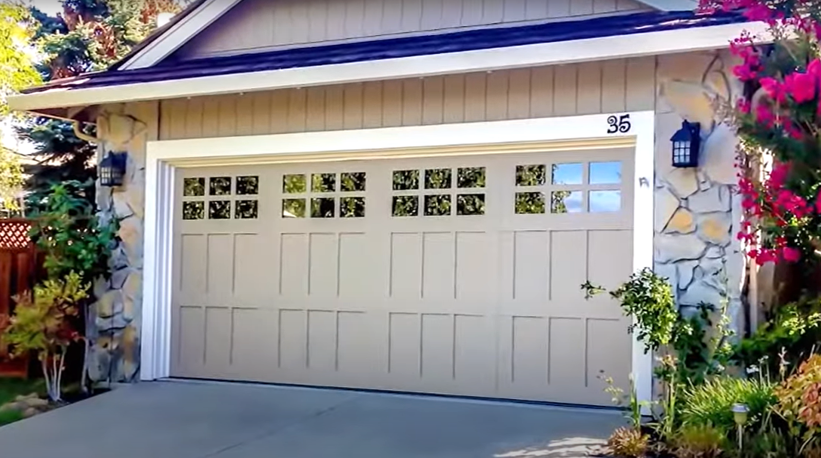 Team of professional technicians performing garage door repair in Sarasota, FL