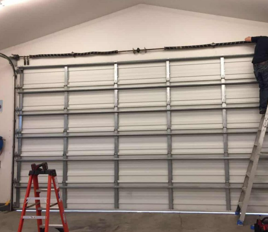 A professional garage door repair service in Sarasota, FL, featuring a newly installed modern and high-quality garage door, highlighting expert and reliable services in the Sarasota area.