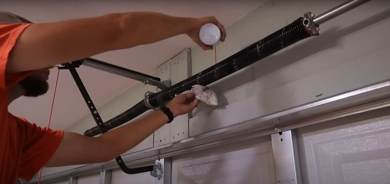 Professional technician repairing a garage door spring at Garage Door Repair Sarasota FL