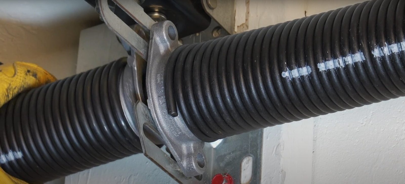 Professional technician repairing a garage door spring at Garage Door Repair Sarasota FL