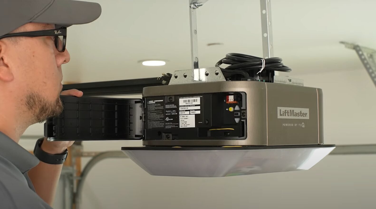 A Garage Door Repair Sarasota FL technician inspecting and repairing a garage door opener to ensure safe and reliable performance